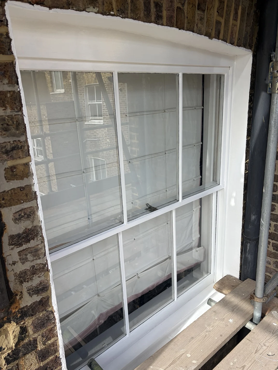 White sash window and surrounding brickwork in Notting Hill